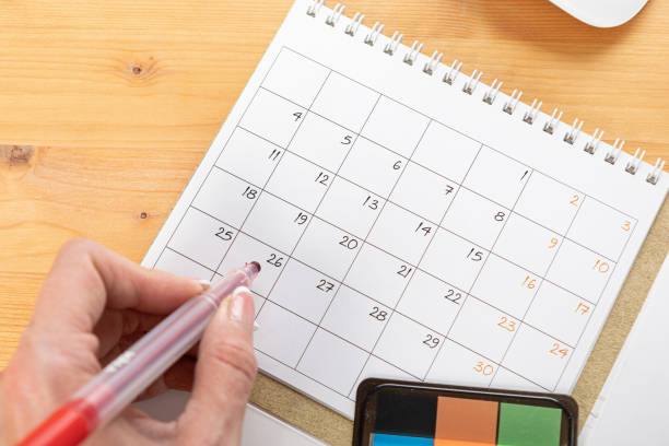 istock Planner plan Schedule Calendar and agenda reminders, work from home online. desktop calendar with stationery and pen pencil, keyboard for plan daily meeting and note holiday trip in diary at office desk. 2023 calendar reminder concept. 1542881118