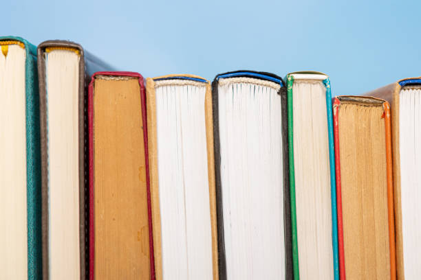 istock Composition with vintage old hardback books, diary on blue background. Books stacking. Back to school. Copy Space. Education background. 1542886529