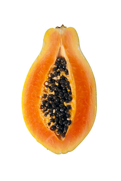 A cross section of a sliced papaya on a white background Sliced papaya isolated on a white background papaya stock pictures, royalty-free photos & images