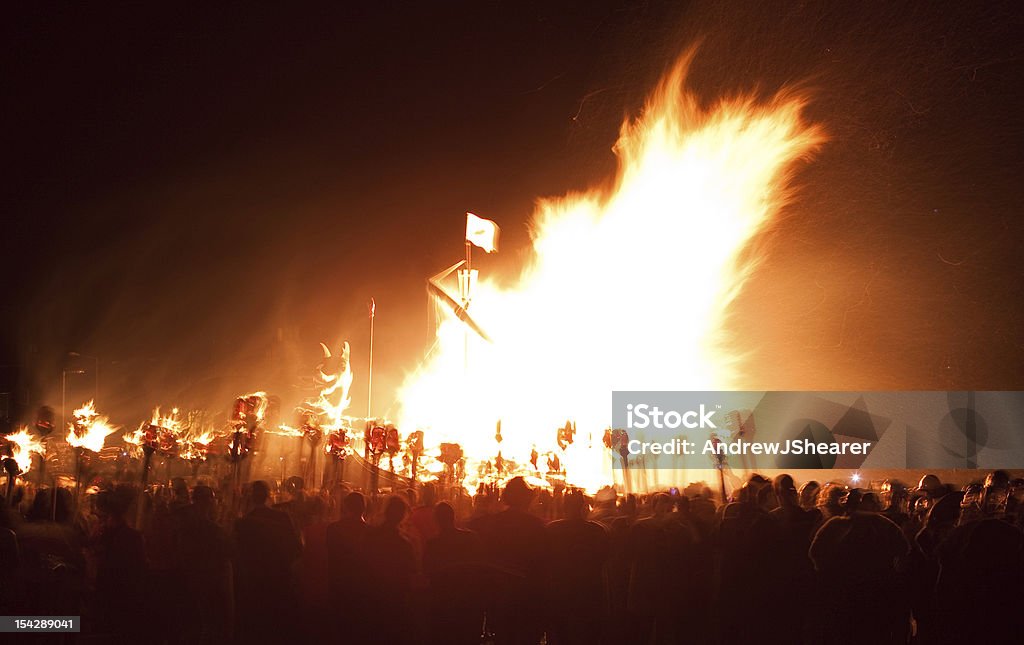 Up Helly Aa Galley Burning The Jarl Squad and Guizers are surrounding the viking galley throwing in their flaming torches.  This image was shot using a slow shutter speed to capture the incredible glow of the flames. Lerwick Stock Photo