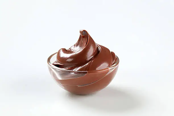chocolate creme in a glass bowl on a white background