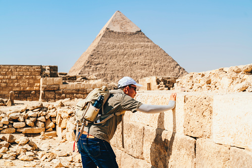 asian archaeologist working an research the pyramid pharaoh in Giza Cairo