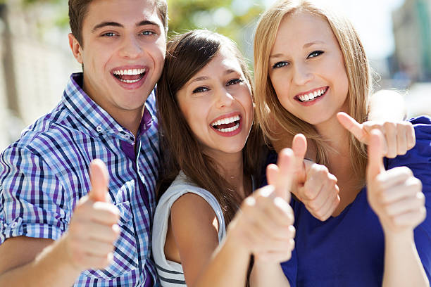 istock Three young friends with thumbs up 154293906