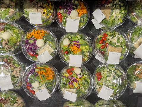 Looking down on bowls of salad in supermarket