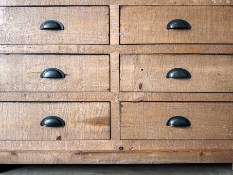 Full frame detail of drawers of a wooden dresser