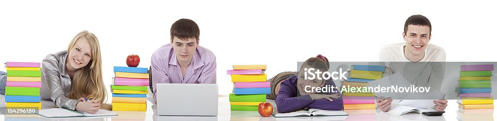 Four Smiling Students and Books. Four Female and Male Students Lying on the Floor with a lot of Colorful Books.http://img-fotki.yandex.ru/get/6200/76420281.0/0_87ea8_16684bf5_L.jpg Book Stock Photo