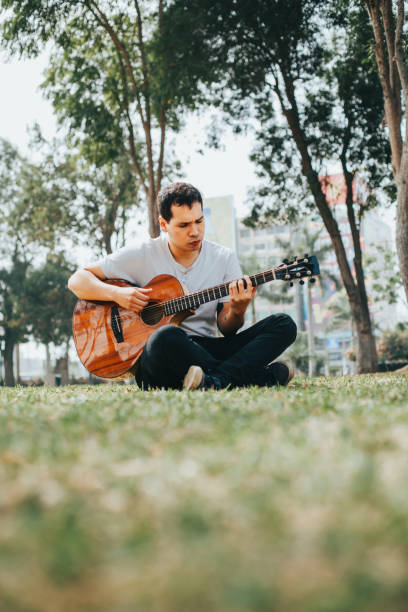 istock Young man playing acoustic guitar. 1543022583