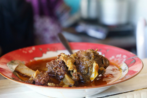 Gule Balungan Kambing Madura is a savory Indonesian dish that features Madurese style goat ribs stewed in a fragrant and flavorful curry like broth. Food Photography.
