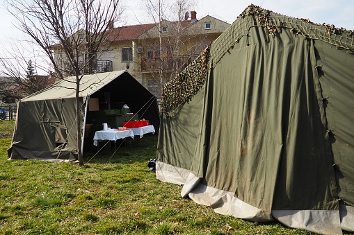 Sremska Mitrovica Serbia 02.19.2022 Competition for the best chef. Field kitchen for festival participants. Preparing dinner outside. Military tent. Military tents are set up on the grass