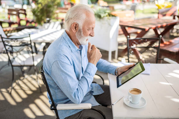 istock Senior Man Enjoying Coffee With His Digital Tablet Outdoors 1543067111