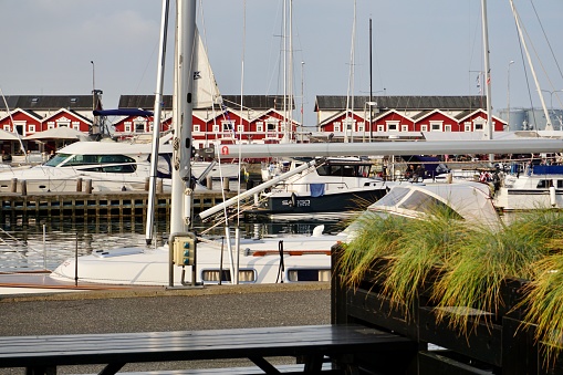 Skagen port in summer. Yachts parked in the port of Skagen. Reflection of yachts in the sea. Reflection of parked yachts in the water.