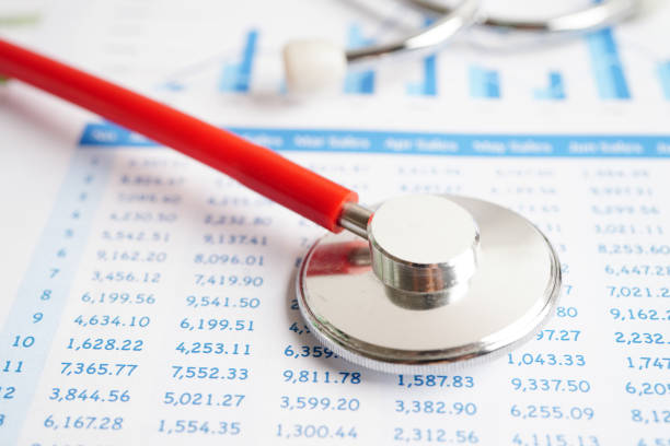 istock Stethoscope and US dollar banknotes on chart or graph paper, Financial, account, statistics and business data  medical health concept. 1543092238