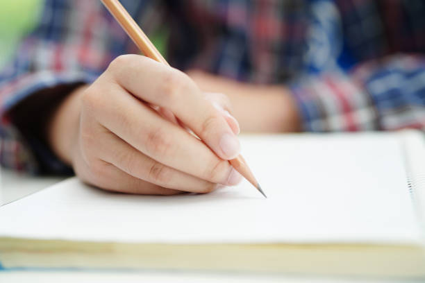 istock Asian teenage student write homework, study lesson for exam online learning education. 1543092269