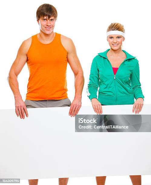 Fitness Girl And Male Athlete With Blank Billboard Stock Photo - Download Image Now - Adult, Billboard, Cut Out