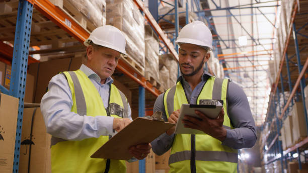 istock Factory, tablet and freight worker team with development and inventory check in warehouse for shipping. Business people, reading and stock strategy with communication and teamwork for industrial job 1543110058