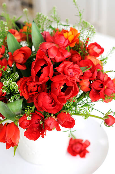 istock Red tulips and ranunculus in a vase 154311065