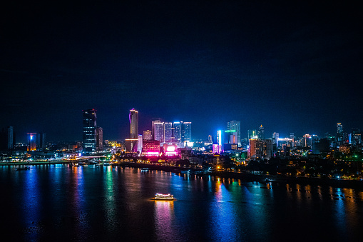 Beautiful reflections of high rise buildings in Phnom Penh on Tonle Sap river, shot from Tonle Sap Rooftop Restaurant