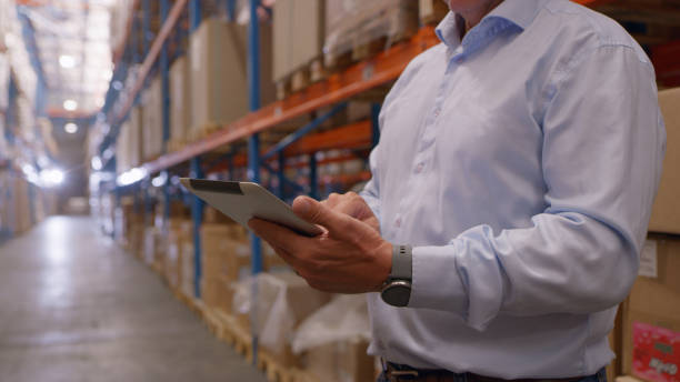 istock Hands, tablet and man in distribution warehouse for shipping logistics, cargo storage or wholesale production. Closeup of manager, digital technology app or check online stock in supply chain factory 1543111659