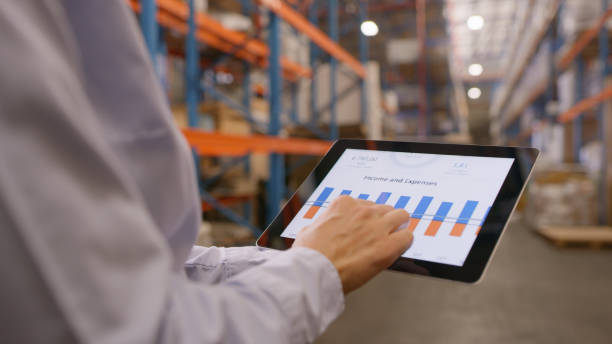 istock Person, hands and tablet with statistics in warehouse for logistics, marketing graph or checking company revenue. Closeup of storage manager working on technology for inventory inspection or expenses 1543113930
