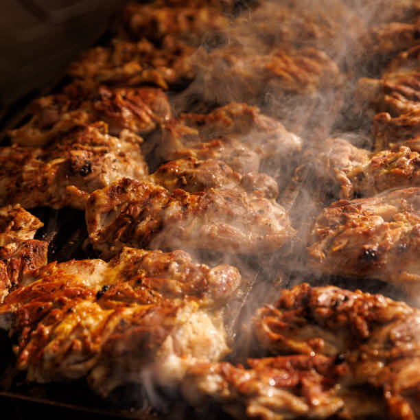 istock Pork steaks cooking in open flame on barbecue grill. 1543115615