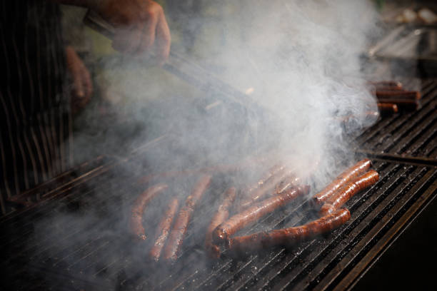 istock Sausages are fried on fire, bbq grill service. 1543115797