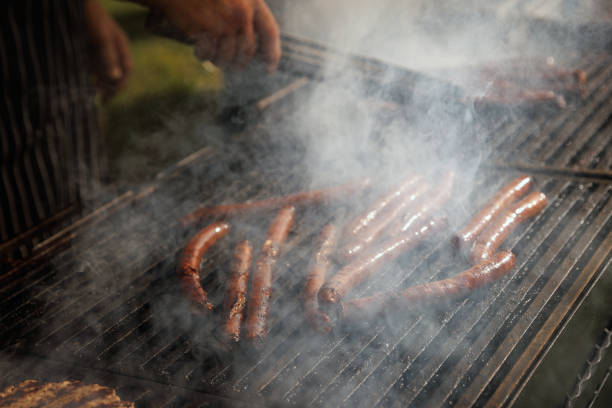 istock Sausages are fried on fire, bbq grill service. 1543116128