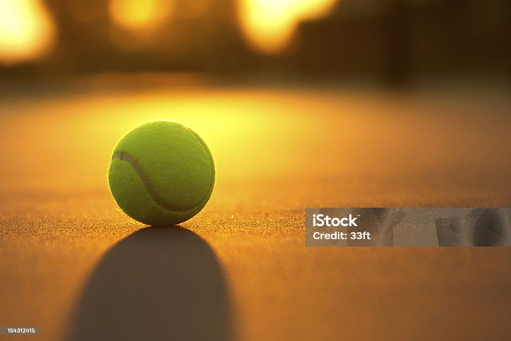 Bola de tenis en la puesta de sol - Foto de stock de Pista dura libre de derechos