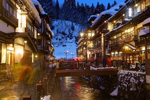 Night scenery of Ginzan Onsen (銀山温泉), a famous hot spring town and tourist destination in Obanazawa, Yamagata, Japan, with bridges over a stream flanked by old buildings on a cold snowy winter evening

Foreign texts translated 