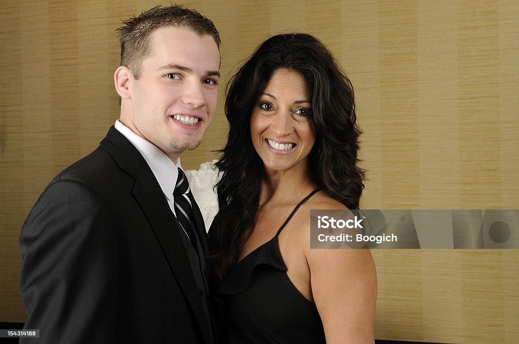 American Couple Older Woman Younger Man Wearing Formal Clothing This is a horizontal color photograph of an attractive older woman with a younger man. They are in formal attire. Happy, they smile and look into the camera. Males Stock Photo