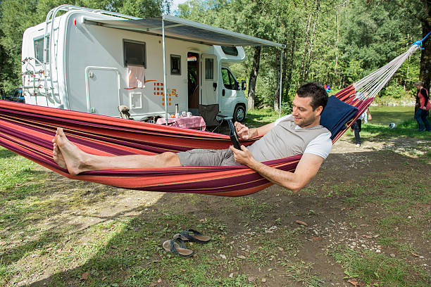 Working during holidays Mature man working during holidays week hammock men lying down digital tablet stock pictures, royalty-free photos & images