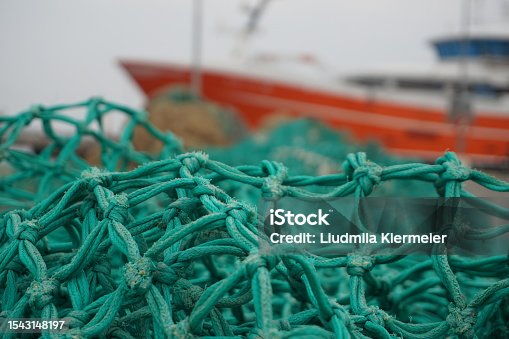 istock Fishing nets. Fishing nets with colorful buoys. Fishing gear and tackle. Industrial fishing. Fishing nets in the port on the floor. 1543148197