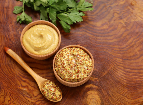 istock Dijon mustard in wooden bowls on the table 1543162004