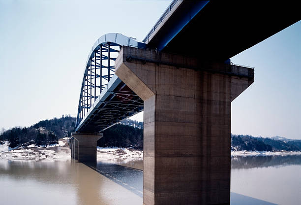 istock Arch bridge is built over the dam 154317068