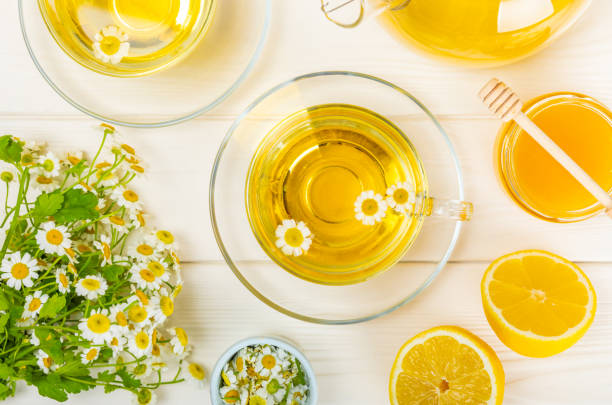 istock Chamomile tea in a  cup on a texture background. Natural hour with chamomile flowers. Herbal tea. Immunity tea.Natural healer concept. Healthy detox drink.Close up. Place for text. 1543178151
