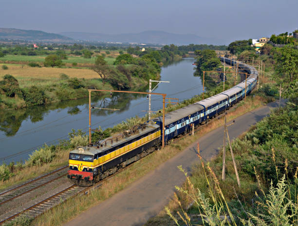 istock Express passenger train passing parallel to river Indrayani in Kamshet, Maharashtra, India 1543179877