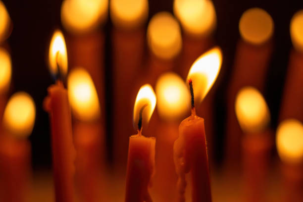 Candle flame, Yellow candle light burn against black background.