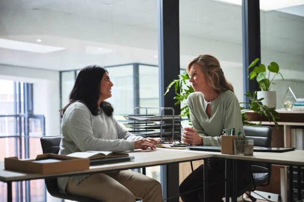 istock Creative workplace, discussion and business women in conversation for planning, ideas and strategy. Eco friendly office, corporate and female worker talking at desk for project, task and meeting 1543197212