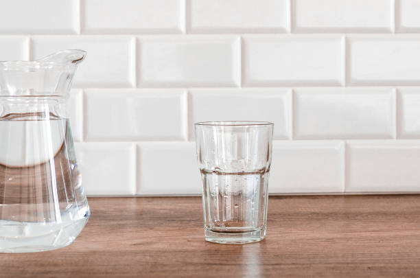 istock Jug and glass with water on white background 1543206435
