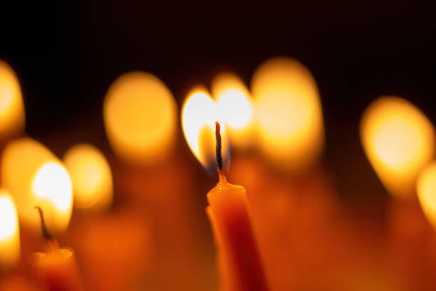 Candle flame, Yellow candle light burn against black background.