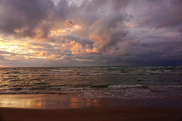 istock Multicolored sky during sunset in Scandinavia. Bronze sky during sunset on the beach of Denmark. Denmark beach at sunset. Kjul Beach at sunset. Sunset in Hirtshals. 1543287413