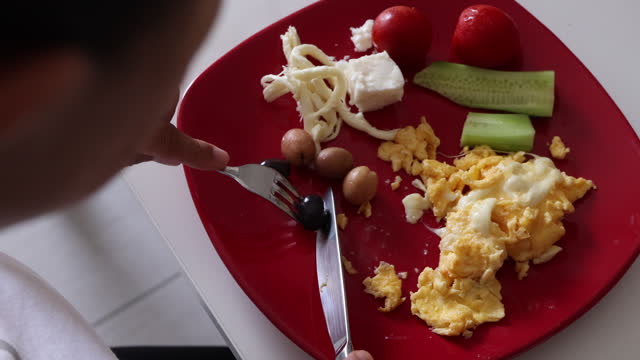 Woman eats omelet for breakfast