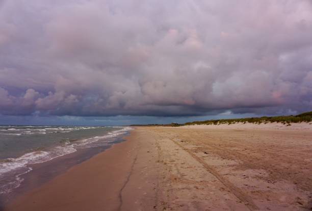istock Multicolored sky during sunset in Scandinavia. Bronze sky during sunset on the beach of Denmark. Denmark beach at sunset. Kjul Beach at sunset. Sunset in Hirtshals. 1543294196