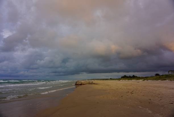 istock Multicolored sky during sunset in Scandinavia. Bronze sky during sunset on the beach of Denmark. Denmark beach at sunset. Kjul Beach at sunset. Sunset in Hirtshals. 1543303265