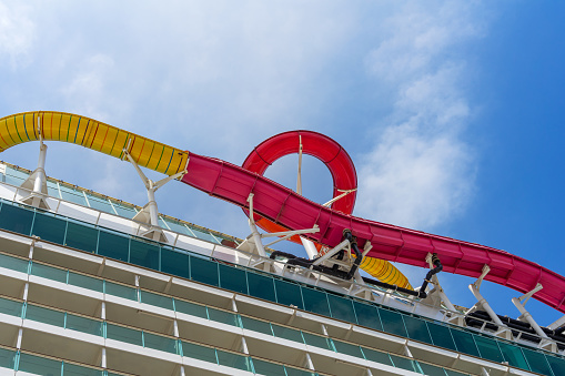 Ensenada, BC, Mexico – June 4, 2023: Royal Caribbean’s Navigator of the Seas cruise ship with view of water slide and balconies on the port side.