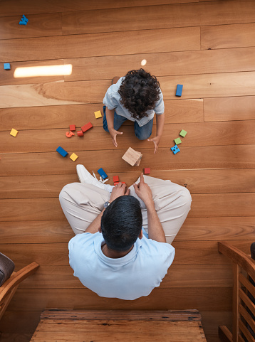 Building blocks, toys and top view of father with baby on floor for playing, educational games and learning. Child development, family and above of dad and boy for creative fun, bonding and love