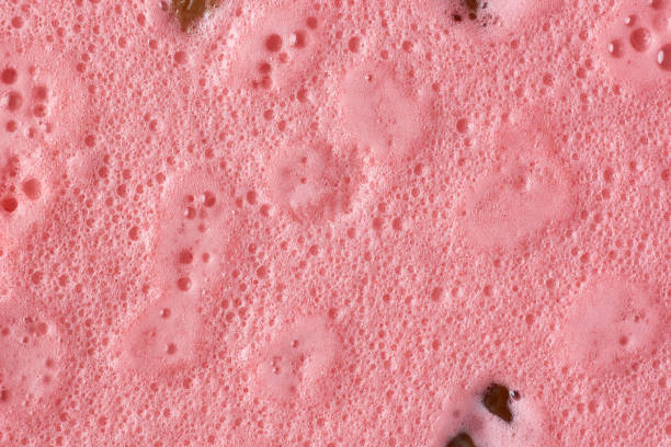 abstract of jelly pudding surface, delicious sweet dish made with fresh cream, condensed milk and strawberry jelly and spread prune in full frame background, taken straight from above