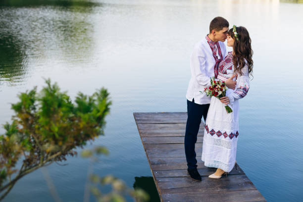 girl in an embroidered dress with a wedding bouquet closed her e