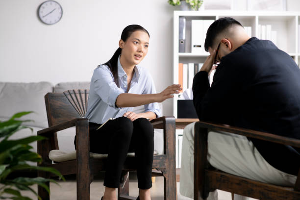 istock Young Asian man with mental health problem talking and consulting therapist 1543374412