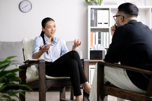 istock Young Asian man with mental health problem talking and consulting therapist 1543374428
