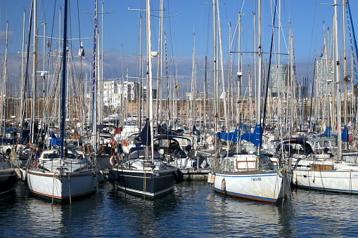 03/17/2015 Barcelona, Spain: The picture captures boats in Port Vell, Barcelona. The boats fill the marina, creating a charming scene against the backdrop of the city's skyline. The image showcases the diversity of vessels, from small fishing boats to luxurious yachts. It provides a glimpse into the bustling maritime activities that take place in this vibrant port.